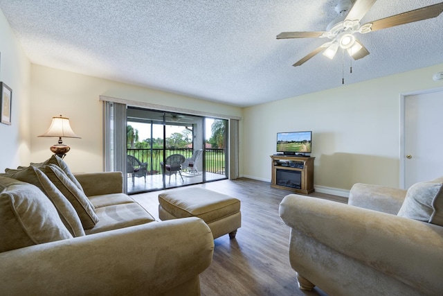 13403 Touchstone Pl Unit A-202, Palm Beach Gardens, FL 33418 - living room featuring wood finished floors, a textured ceiling, ceiling fan, and baseboards