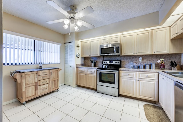 13403 Touchstone Pl Unit A-202, Palm Beach Gardens, FL 33418 - kitchen with appliances with stainless steel finishes, tasteful backsplash, a textured ceiling, ceiling fan, and light countertops
