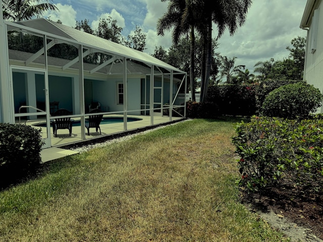 2616 E Community Dr, Jupiter, FL 33458 - view of grassy yard with a patio, an outdoor pool, and a lanai