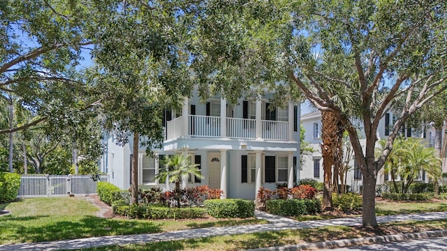 2616 E Community Dr, Jupiter, FL 33458 - view of front of home with a balcony, stucco siding, a gate, and fence