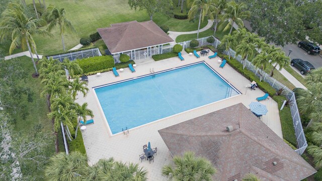 2616 E Community Dr, Jupiter, FL 33458 - community pool featuring fence and a patio