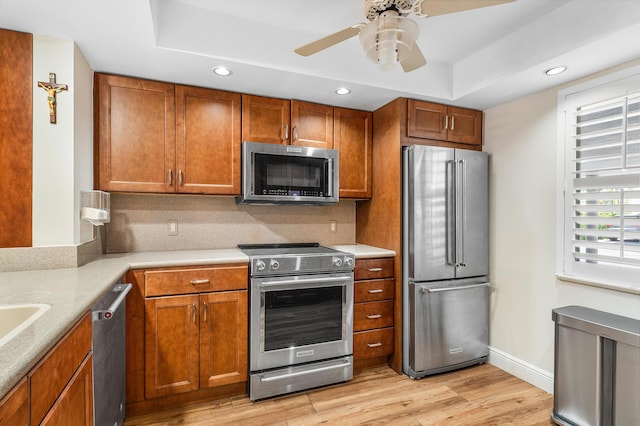 911 Gardenia Dr Unit 154, Delray Beach, FL 33483 - kitchen featuring stainless steel appliances, brown cabinets, light wood-style flooring, and recessed lighting