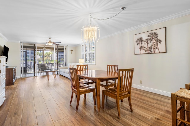911 Gardenia Dr Unit 154, Delray Beach, FL 33483 - dining space with crown molding, wood finished floors, baseboards, and ceiling fan with notable chandelier