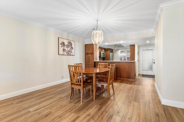 911 Gardenia Dr Unit 154, Delray Beach, FL 33483 - dining space featuring light wood-style floors, a chandelier, baseboards, and ornamental molding