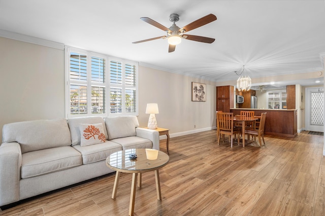 911 Gardenia Dr Unit 154, Delray Beach, FL 33483 - living room with crown molding, baseboards, light wood-style flooring, and ceiling fan with notable chandelier