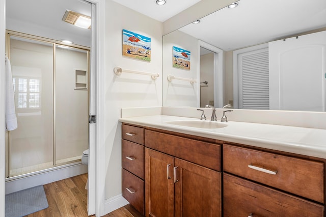 911 Gardenia Dr Unit 154, Delray Beach, FL 33483 - bathroom featuring toilet, wood finished floors, vanity, a shower stall, and baseboards