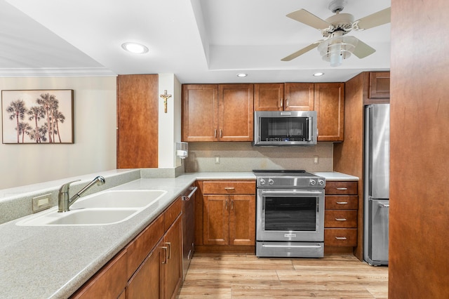 911 Gardenia Dr Unit 154, Delray Beach, FL 33483 - kitchen featuring stainless steel appliances, brown cabinetry, a ceiling fan, and a sink