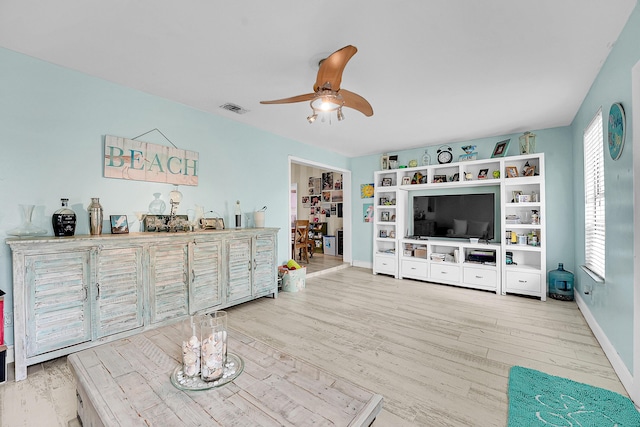 1742 SW Hampshire Ln, Port Saint Lucie, FL 34953 - living room featuring a ceiling fan, wood finished floors, and baseboards
