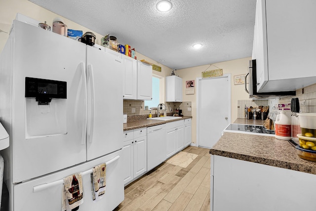 1742 SW Hampshire Ln, Port Saint Lucie, FL 34953 - kitchen with white appliances, a textured ceiling, a sink, white cabinets, and light wood-style flooring