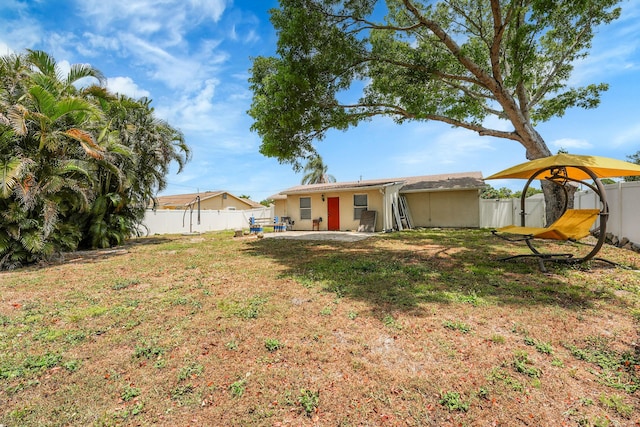 1742 SW Hampshire Ln, Port Saint Lucie, FL 34953 - view of yard featuring a patio area