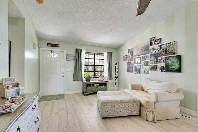 1742 SW Hampshire Ln, Port Saint Lucie, FL 34953 - sitting room with light wood finished floors, a textured ceiling, and baseboards