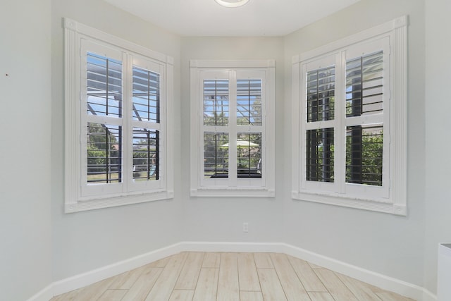 empty room with wood finished floors and baseboards