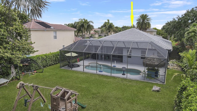 outdoor pool with a lawn, glass enclosure, a patio, and a hot tub