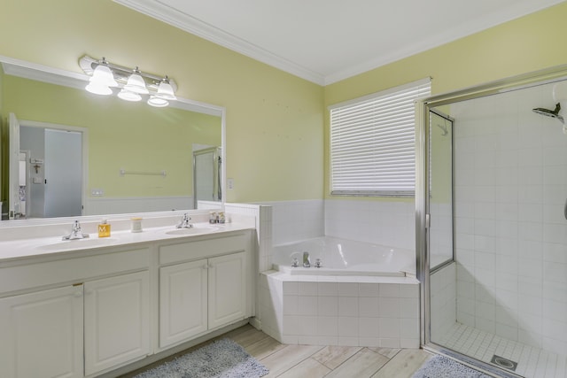bathroom with double vanity, a bath, a shower stall, and a sink