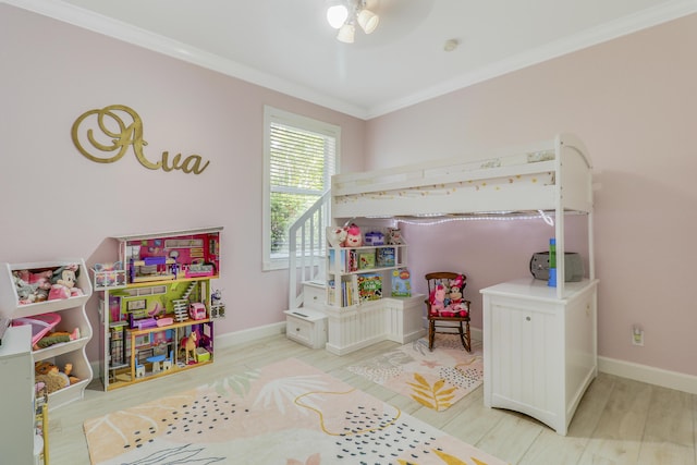 bedroom with crown molding, wood finished floors, and baseboards