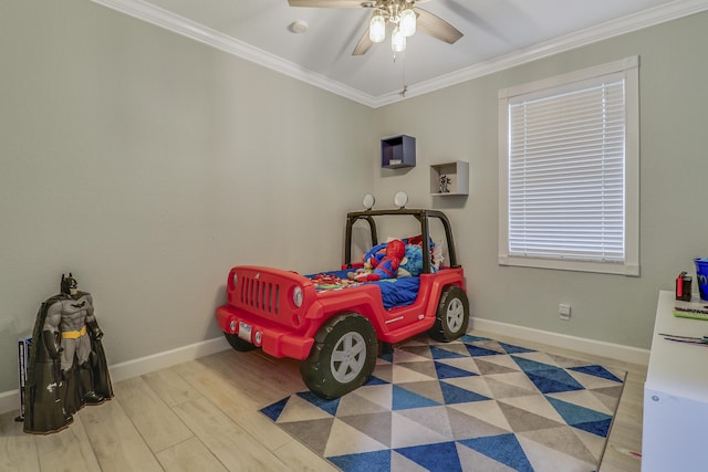 bedroom with baseboards, ornamental molding, ceiling fan, and wood finished floors