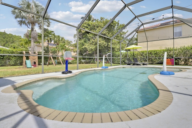 pool featuring a patio area, a playground, and glass enclosure