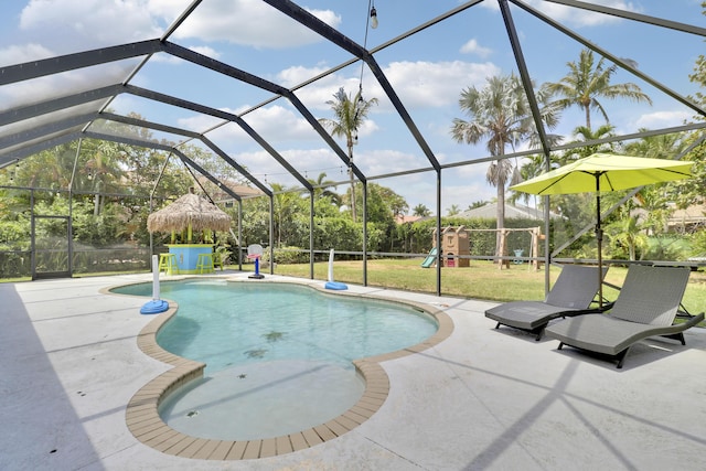outdoor pool featuring a yard, a patio area, a playground, and a lanai