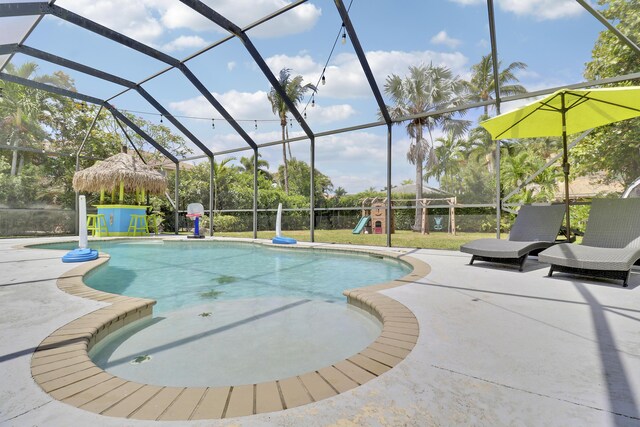 outdoor pool with a lanai, a playground, and a patio