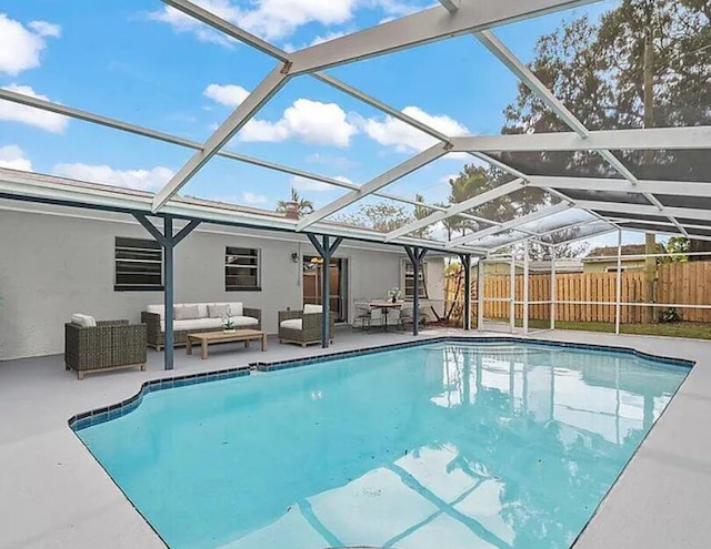 view of pool with an outdoor living space, fence, a patio, and a lanai