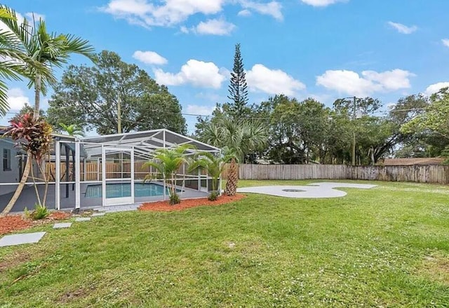 view of yard with glass enclosure