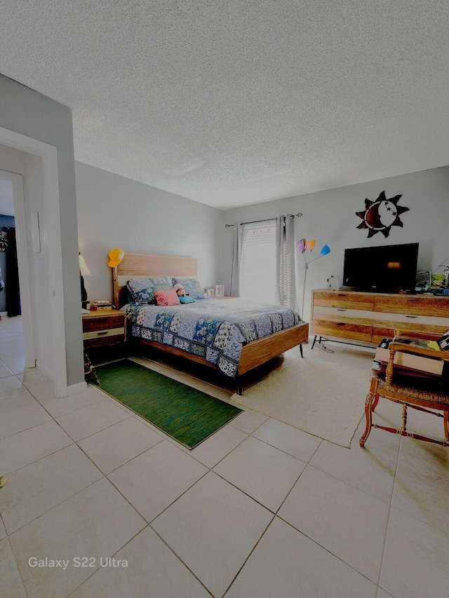tiled bedroom with a textured ceiling