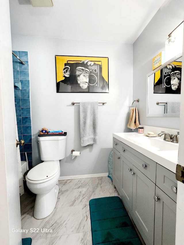 full bathroom with vanity, toilet, baseboards, and marble finish floor