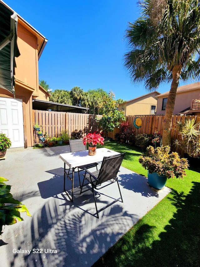view of patio with outdoor dining area and a fenced backyard
