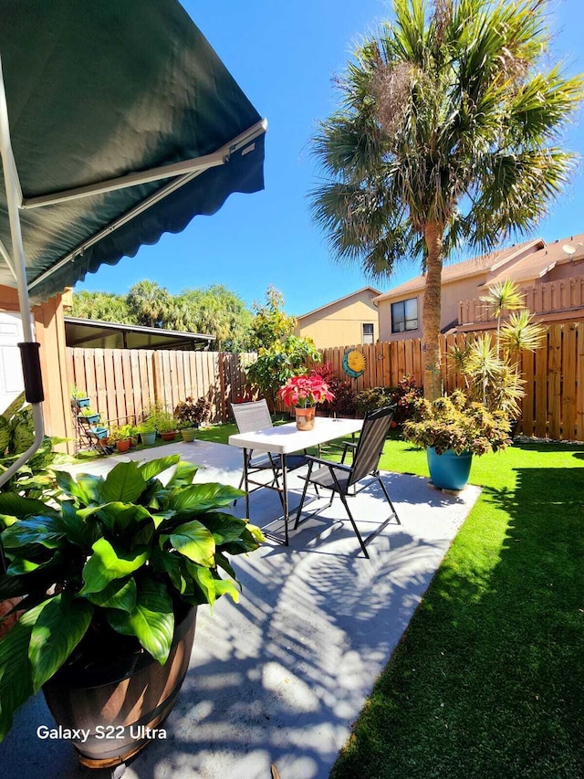 view of patio with a fenced backyard and outdoor dining area