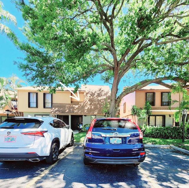 view of front of home featuring stucco siding and uncovered parking
