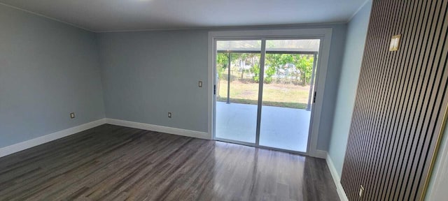 unfurnished room featuring a heating unit, baseboards, ornamental molding, and dark wood-style floors