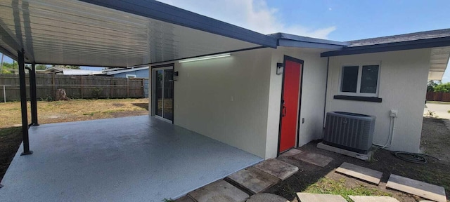 exterior space with central AC unit, fence, a patio, and stucco siding