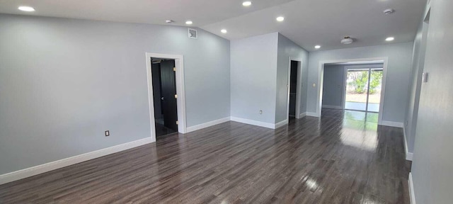 unfurnished room featuring lofted ceiling, recessed lighting, baseboards, visible vents, and dark wood-type flooring