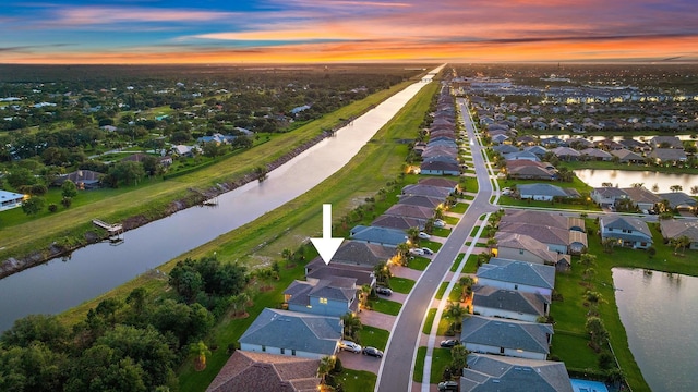 656 SE Villandry Way, Port Saint Lucie, FL 34984 - aerial view at dusk of a residential view and a water view