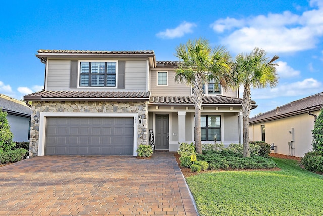 656 SE Villandry Way, Port Saint Lucie, FL 34984 - view of front of property with a tile roof, an attached garage, decorative driveway, and stone siding