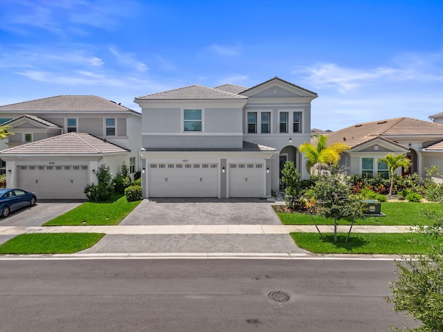 5651 Macoon Way, Westlake, FL 33470 - view of front of home featuring driveway, stucco siding, an attached garage, and a tiled roof
