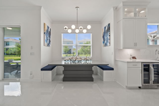 5651 Macoon Way, Westlake, FL 33470 - dining area with beverage cooler, light tile patterned floors, ornamental molding, breakfast area, and a chandelier