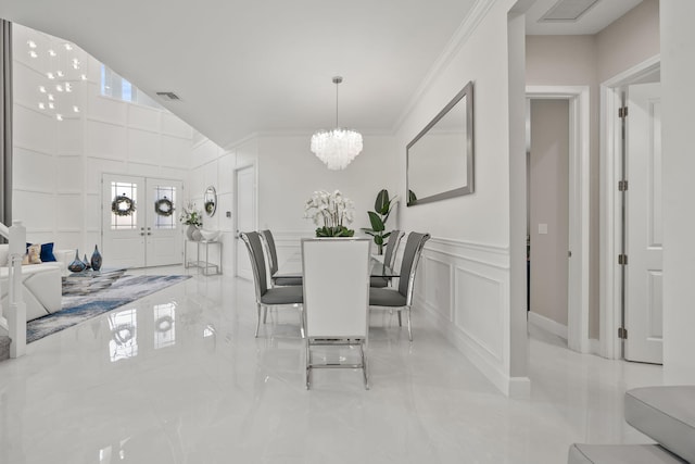 5651 Macoon Way, Westlake, FL 33470 - dining space with a decorative wall, a chandelier, ornamental molding, and marble tiled flooring