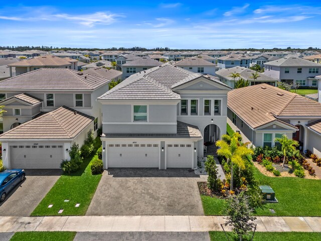 5651 Macoon Way, Westlake, FL 33470 - view of front facade with a residential view, stucco siding, driveway, a tiled roof, and a front lawn