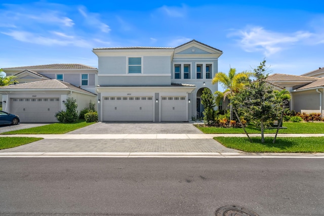 5651 Macoon Way, Westlake, FL 33470 - traditional home with a garage, driveway, and stucco siding