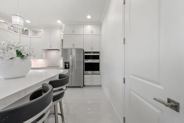 5651 Macoon Way, Westlake, FL 33470 - kitchen with stainless steel appliances, recessed lighting, white cabinetry, glass insert cabinets, and a kitchen breakfast bar