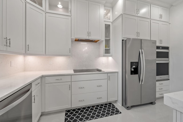 5651 Macoon Way, Westlake, FL 33470 - kitchen featuring appliances with stainless steel finishes, decorative backsplash, and white cabinets