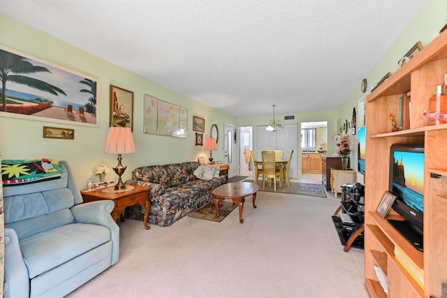 living area with carpet floors and a textured ceiling