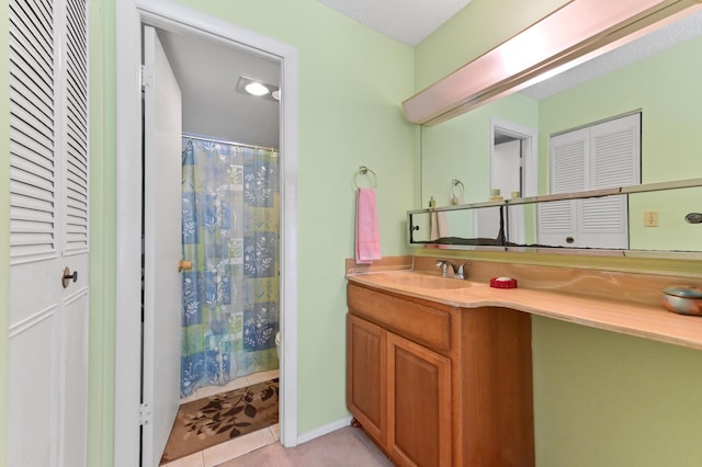 bathroom with a closet, vanity, and a shower with curtain