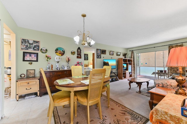 dining area featuring a chandelier and light tile patterned flooring