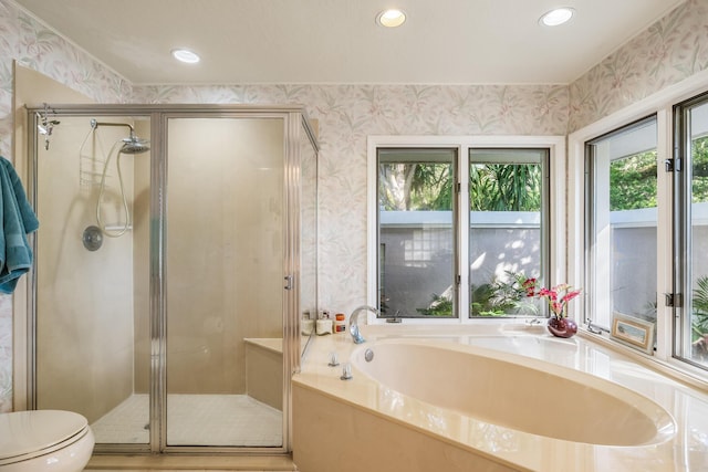 full bathroom with a stall shower, a bath, wallpapered walls, and recessed lighting