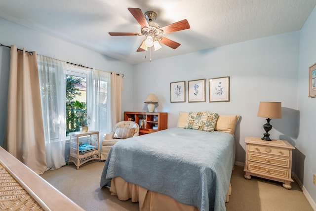 carpeted bedroom with baseboards and a ceiling fan