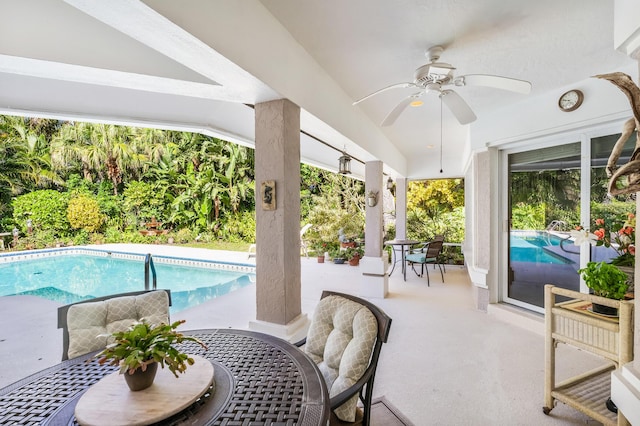 outdoor pool featuring a patio area, outdoor dining area, and ceiling fan