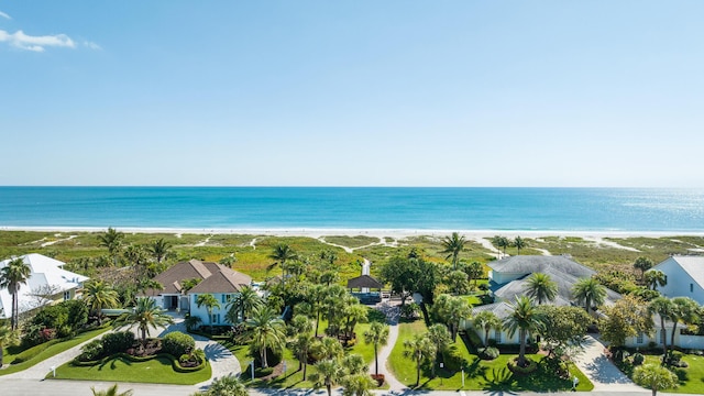 birds eye view of property with a beach view and a water view