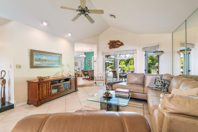 living area featuring high vaulted ceiling, visible vents, ceiling fan, light tile patterned floors, and baseboards